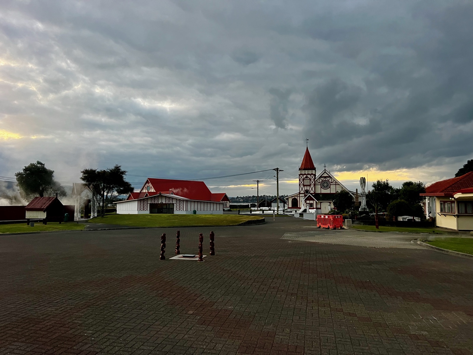 Dusk at Ōhinemutu — steam drifting past the marae buildings and St Faith's church